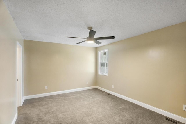 unfurnished room with ceiling fan, a textured ceiling, and light colored carpet