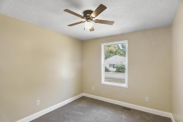 carpeted spare room with a textured ceiling and ceiling fan