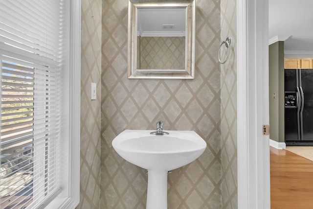 bathroom featuring crown molding and hardwood / wood-style flooring