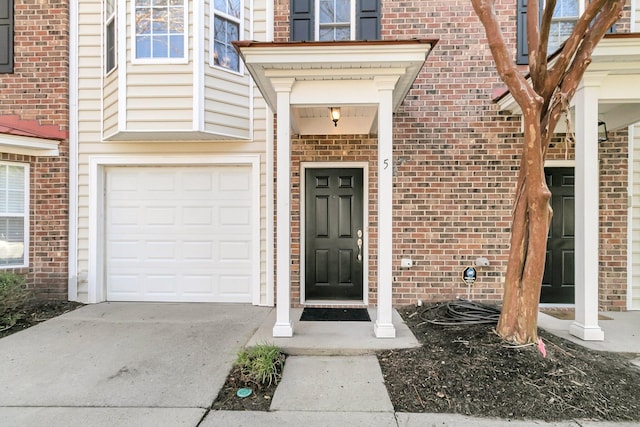 doorway to property with a garage