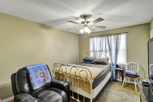 bedroom featuring carpet flooring, a textured ceiling, and ceiling fan