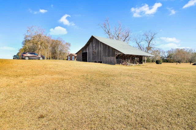 view of home's exterior featuring a lawn and an outbuilding