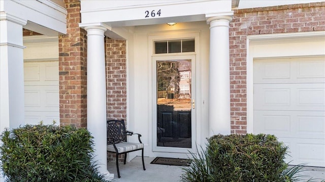 view of exterior entry with brick siding