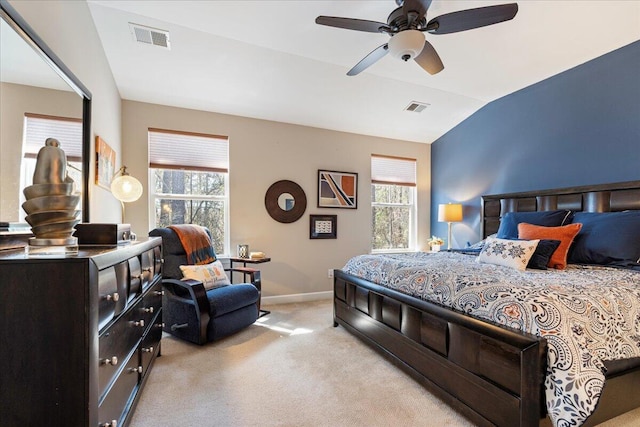 bedroom featuring multiple windows, visible vents, and light colored carpet