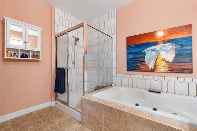 full bath with baseboards, tile patterned flooring, a garden tub, and a shower stall