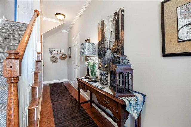 entrance foyer with baseboards, wood finished floors, stairs, and crown molding