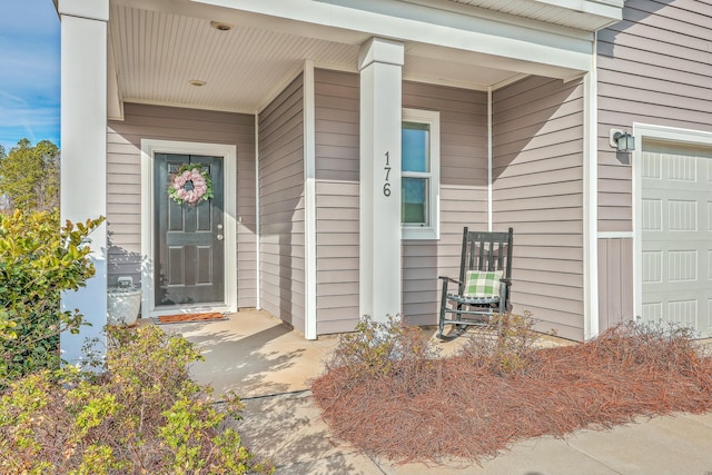 view of exterior entry with a garage