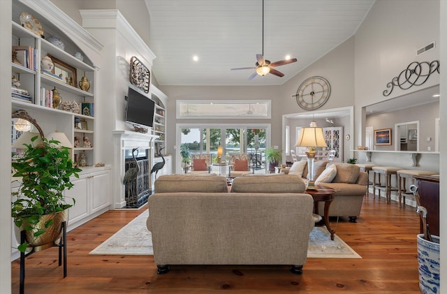 3948 Gift Blvd, Johns Island, SC 29455 - living area featuring a fireplace with flush hearth, high vaulted ceiling, a ceiling fan, and wood-type flooring