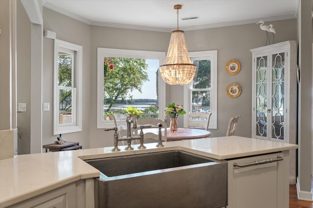 3948 Gift Blvd, Johns Island, SC 29455 - kitchen with a sink, a chandelier, light countertops, pendant lighting, and ornamental molding