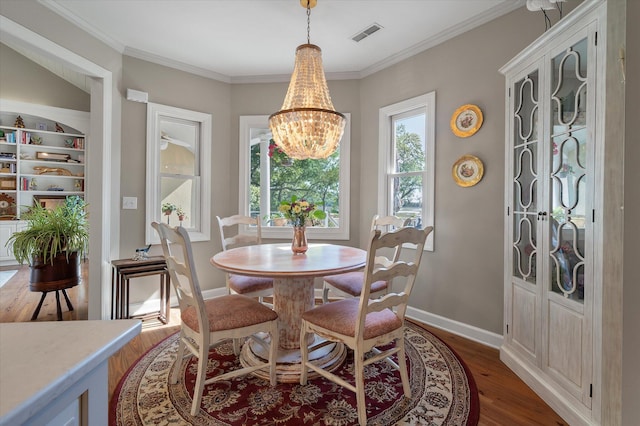 3948 Gift Blvd, Johns Island, SC 29455 - dining room featuring wood finished floors, a chandelier, crown molding, and baseboards