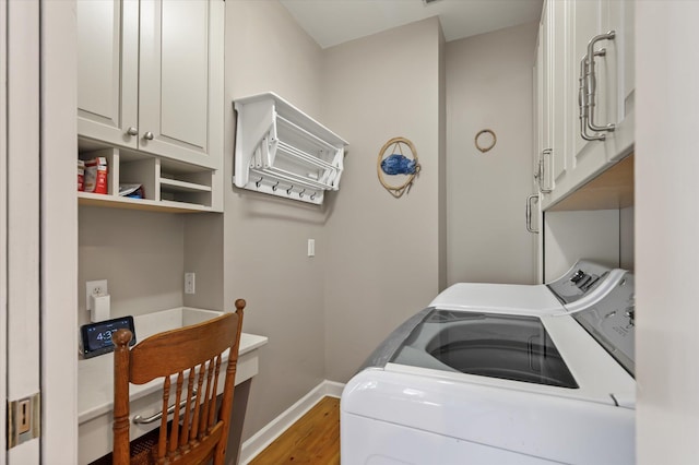 3948 Gift Blvd, Johns Island, SC 29455 - washroom featuring independent washer and dryer, baseboards, cabinet space, and light wood-style flooring