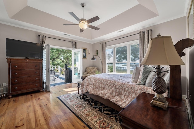 3948 Gift Blvd, Johns Island, SC 29455 - bedroom featuring a raised ceiling, access to exterior, multiple windows, light wood-type flooring, and ornamental molding