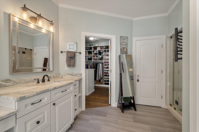 3948 Gift Blvd, Johns Island, SC 29455 - full bathroom with wood finished floors, ornamental molding, vanity, a spacious closet, and a stall shower
