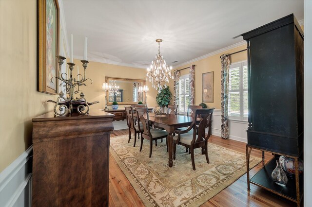 3948 Gift Blvd, Johns Island, SC 29455 - dining room with a chandelier, crown molding, a wainscoted wall, and light wood-style flooring