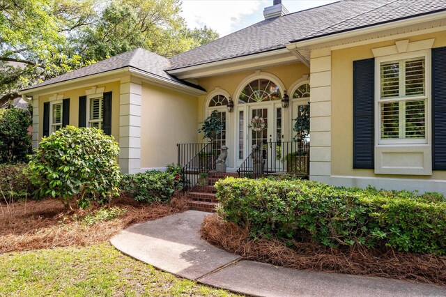 3948 Gift Blvd, Johns Island, SC 29455 - doorway to property featuring a shingled roof, a chimney, french doors, and stucco siding