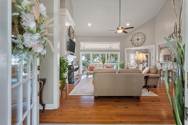 3948 Gift Blvd, Johns Island, SC 29455 - living room featuring a fireplace with flush hearth, high vaulted ceiling, ceiling fan, and hardwood / wood-style flooring
