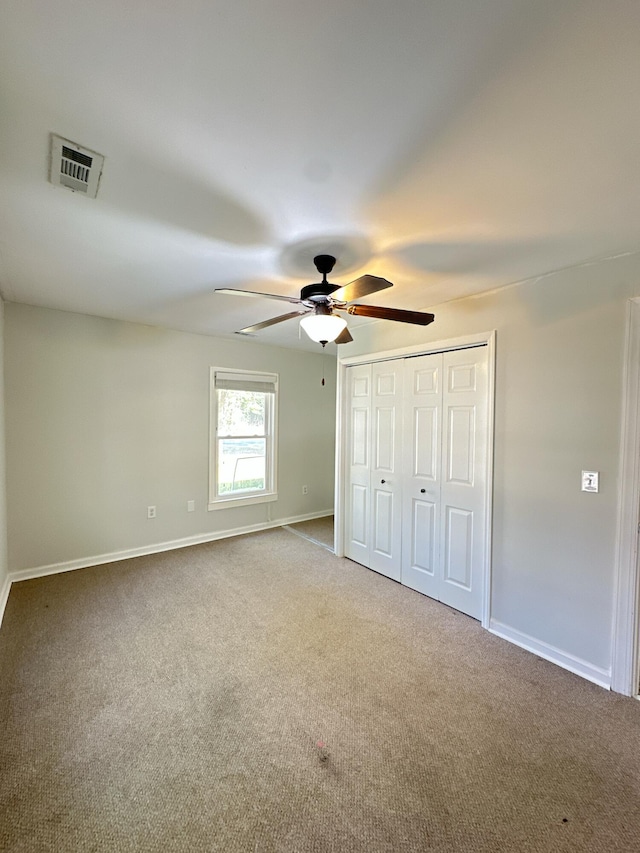 unfurnished bedroom with ceiling fan and carpet floors