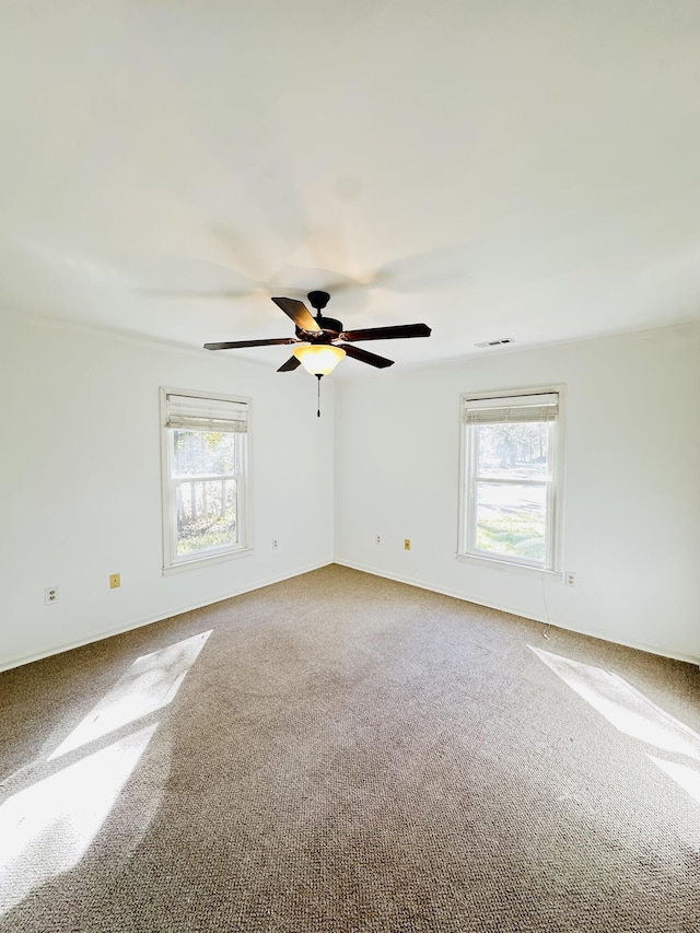 spare room with ceiling fan and carpet floors