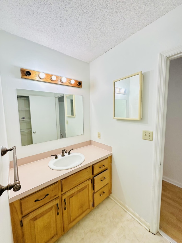 bathroom featuring vanity and a textured ceiling