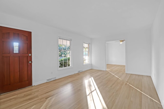 entryway featuring light wood-style flooring, baseboards, and visible vents