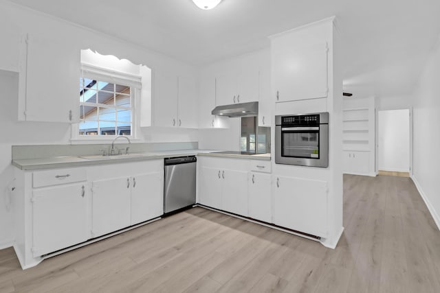 kitchen featuring a sink, stainless steel appliances, light countertops, white cabinets, and under cabinet range hood