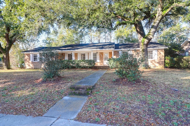 ranch-style house featuring brick siding and a porch