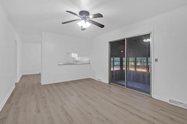 unfurnished living room featuring visible vents, wood finished floors, baseboards, and ceiling fan