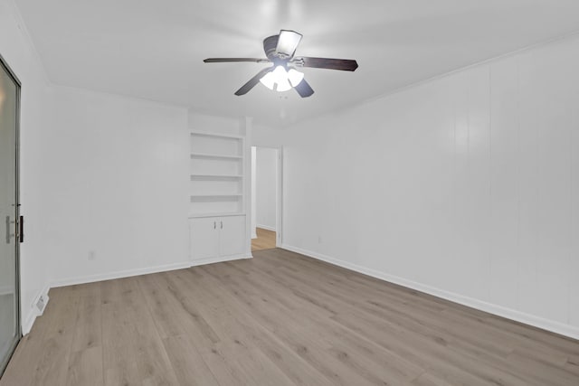 unfurnished room featuring built in features, baseboards, a ceiling fan, and light wood finished floors