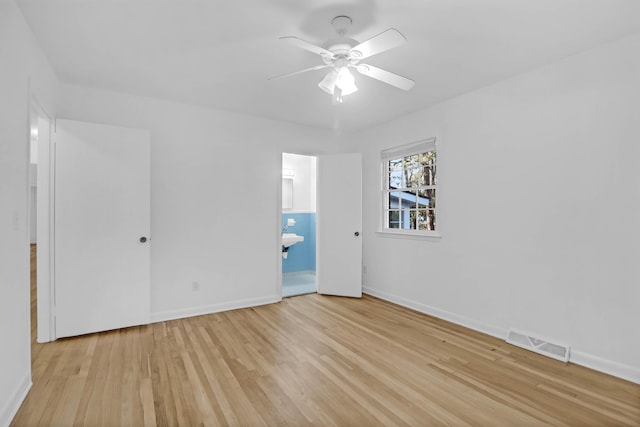 unfurnished bedroom featuring light wood-style flooring, baseboards, and visible vents