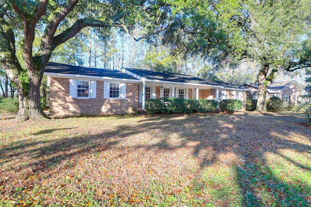 ranch-style house featuring brick siding