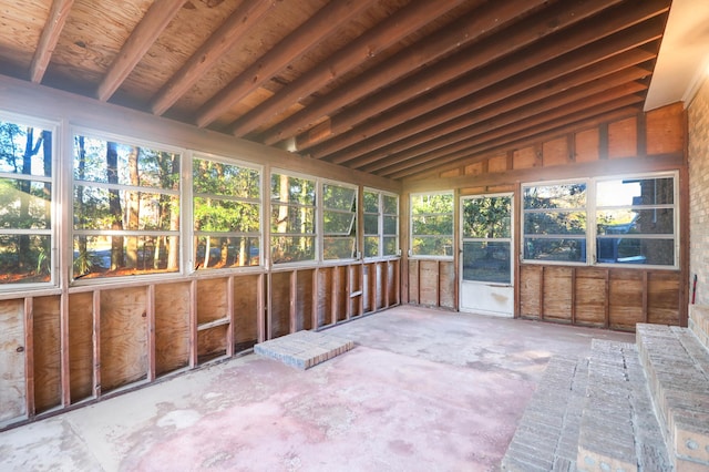 unfurnished sunroom with lofted ceiling