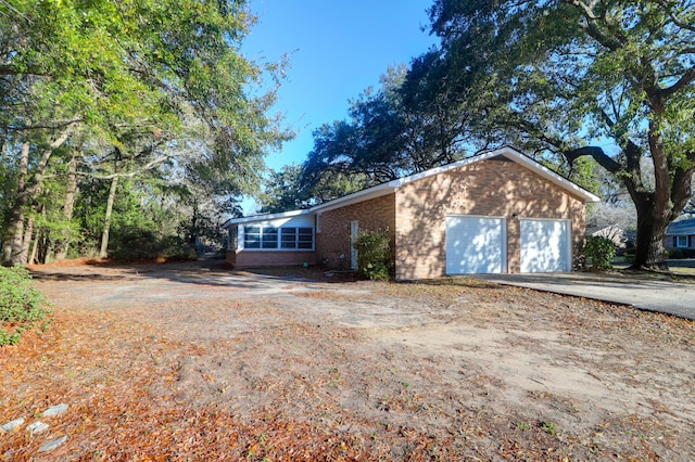 view of front of house with brick siding and driveway