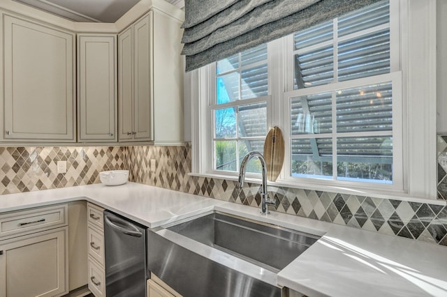 kitchen featuring light countertops, a sink, and backsplash