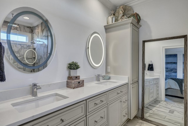 ensuite bathroom with marble finish floor, a sink, and double vanity