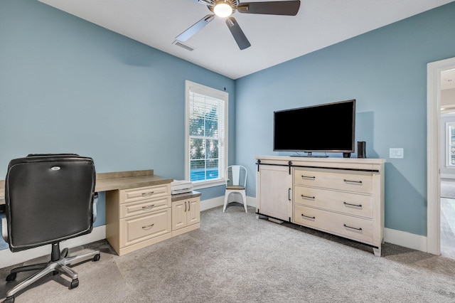 office with light colored carpet, visible vents, ceiling fan, and baseboards