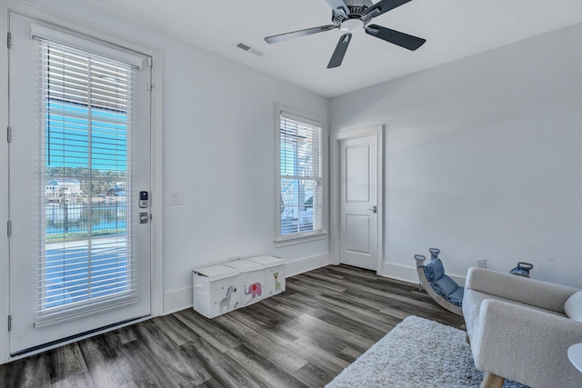 sitting room featuring baseboards, visible vents, and wood finished floors