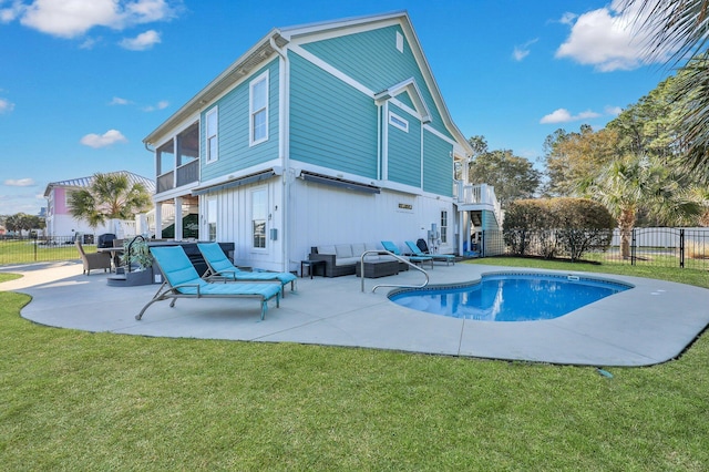 back of house featuring a lawn, an outdoor hangout area, and a patio area