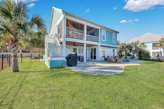 rear view of house with stairway, a ceiling fan, a lawn, fence private yard, and a patio area