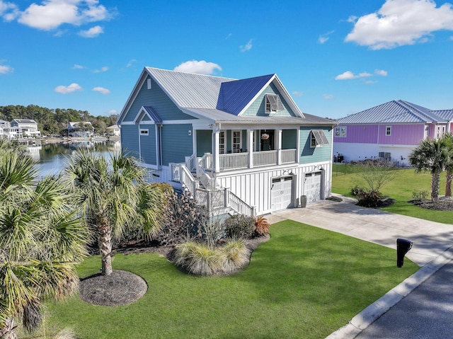 beach home featuring stairs, driveway, a front yard, metal roof, and a porch