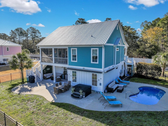 back of house featuring an outdoor living space, stairway, a fenced backyard, a sunroom, and a patio
