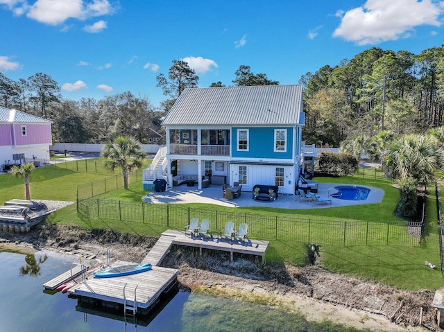 back of property with outdoor lounge area, stairs, a fenced backyard, and a yard
