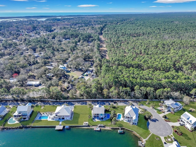 aerial view with a water view and a forest view