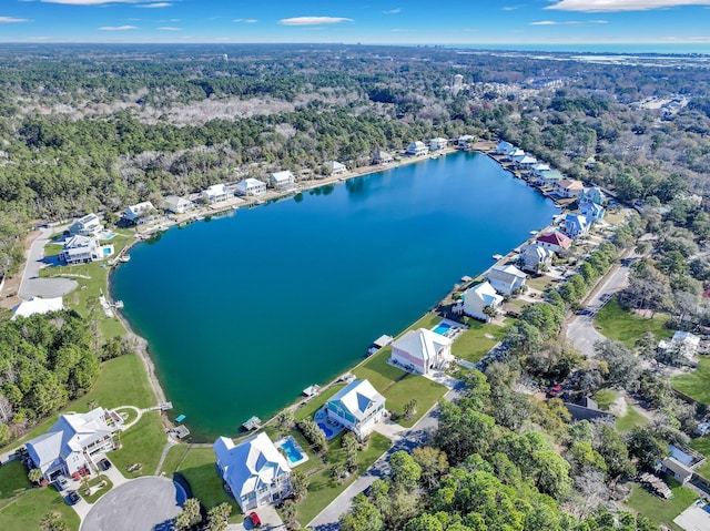aerial view with a water view and a forest view
