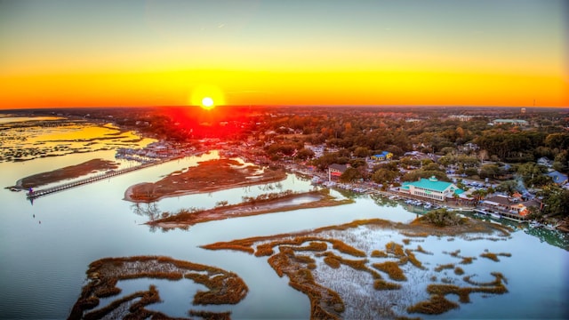 aerial view at dusk featuring a water view