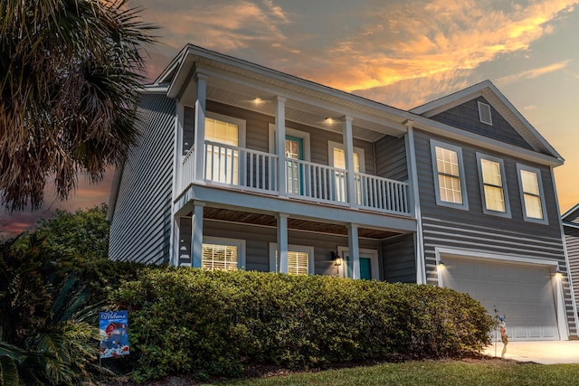 view of front of property with a garage and a balcony
