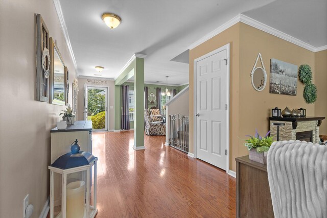 entrance foyer with ornamental molding, baseboards, and wood finished floors