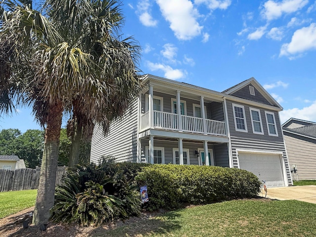 view of front of property with a balcony, a garage, and driveway