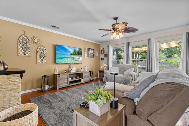 living room with baseboards, crown molding, ceiling fan, and wood finished floors