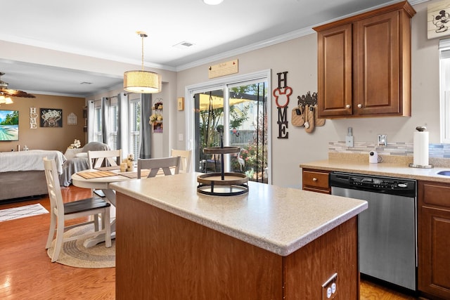 kitchen featuring dishwasher, open floor plan, light countertops, light wood-type flooring, and brown cabinets