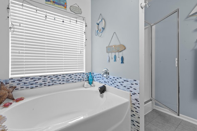 full bath with tile patterned flooring, a garden tub, and a shower stall